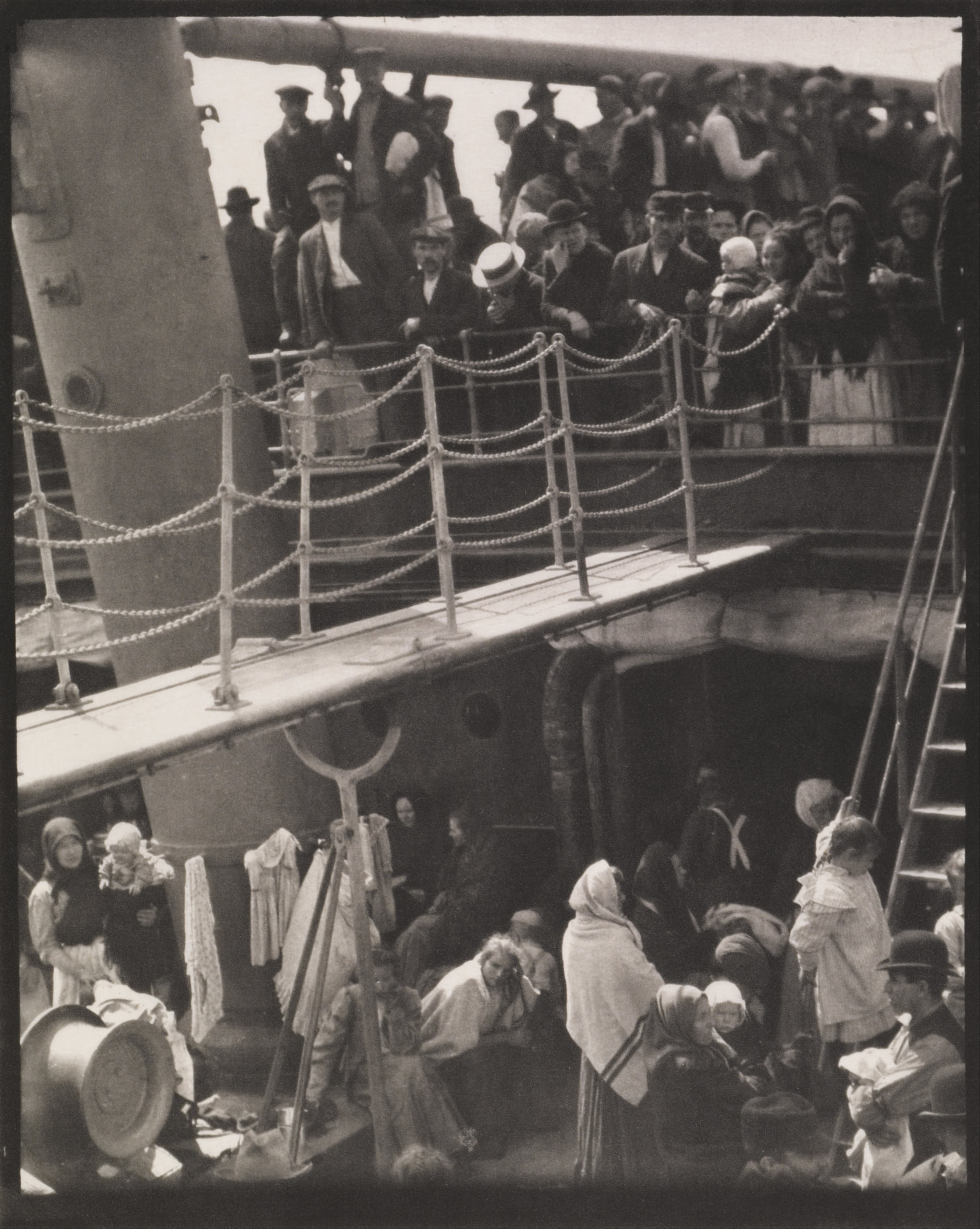 A crowd on a ship's deck, divided by a gangway, 1907